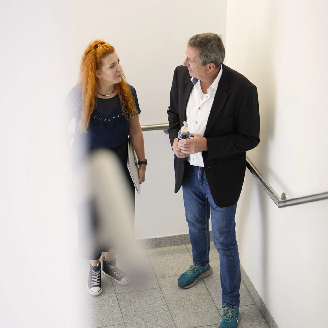 WK IT Spezialisten im Gespräch zu Business Project Services, Foto in Blautönen.